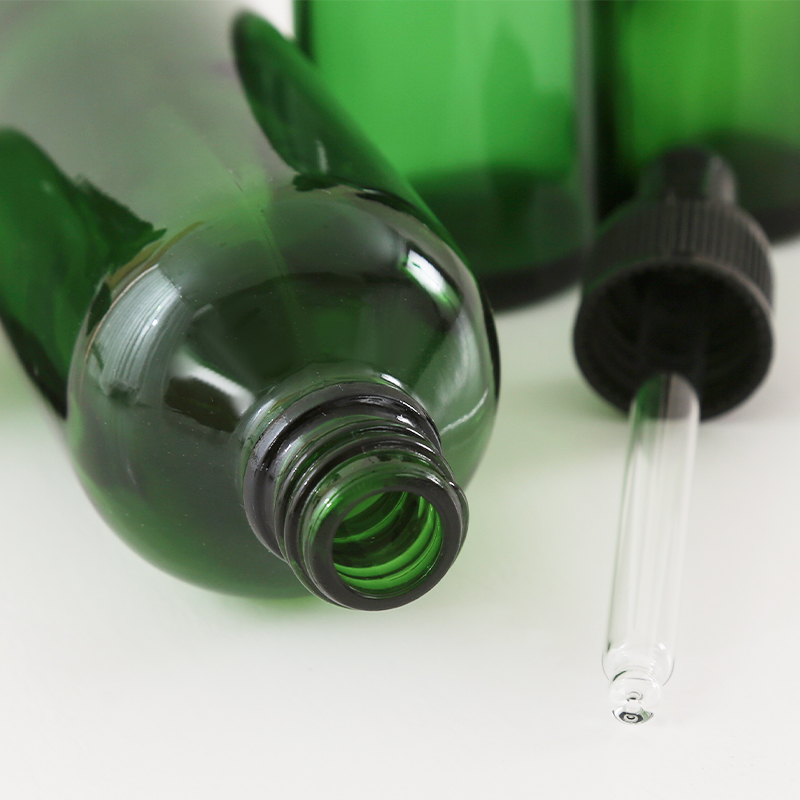 Green glass essential oil bottle