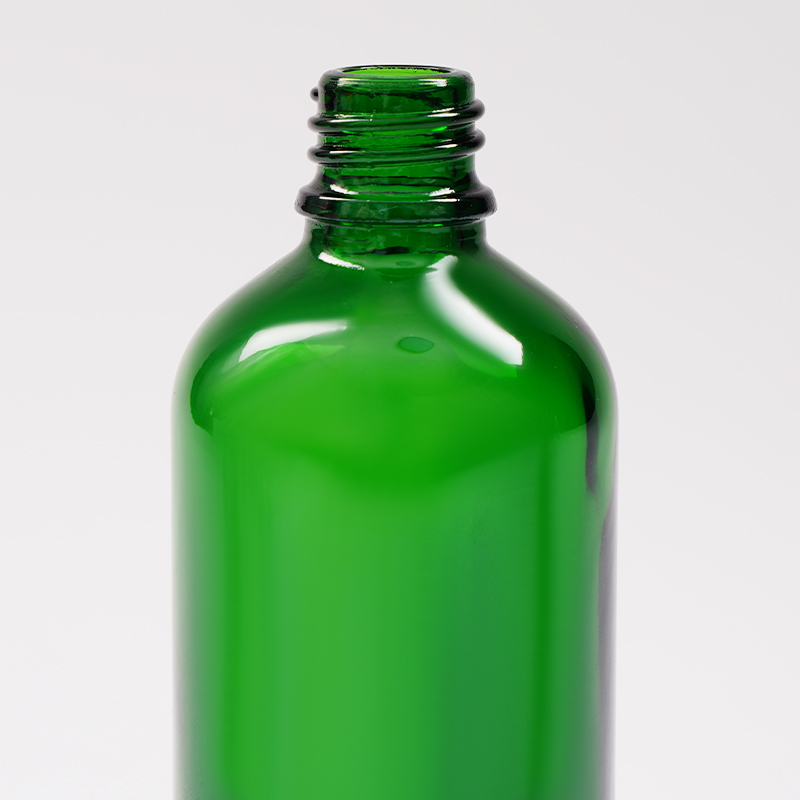Green glass essential oil bottle