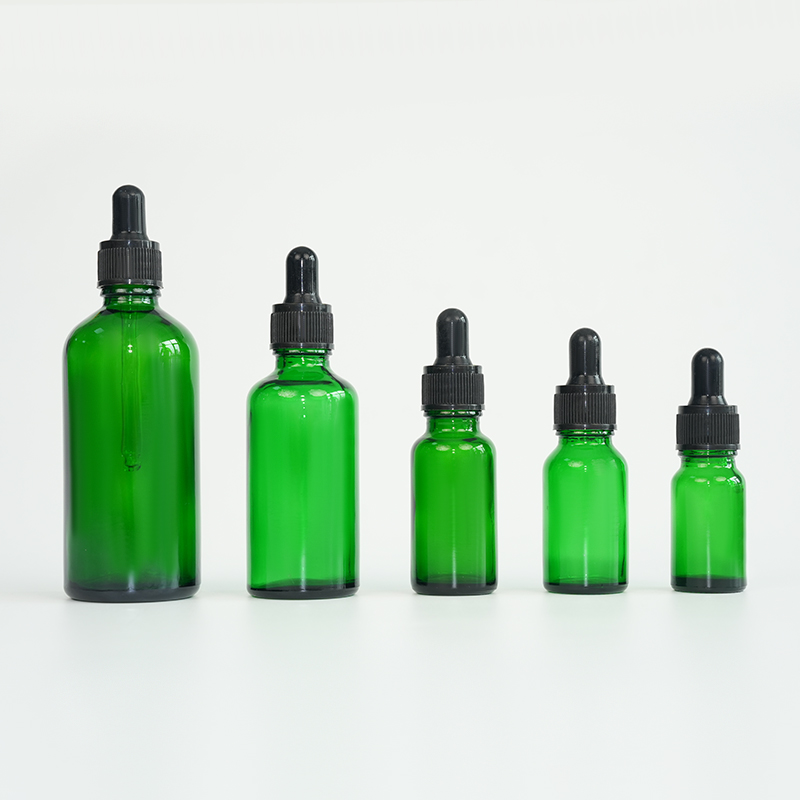 Green glass essential oil bottle