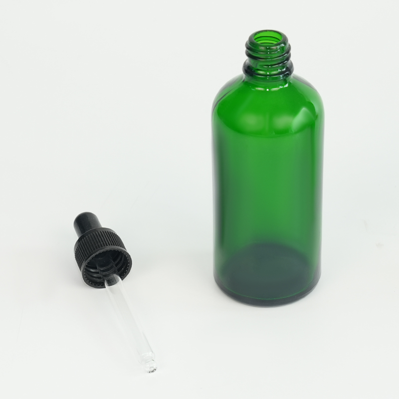 Green glass essential oil bottle